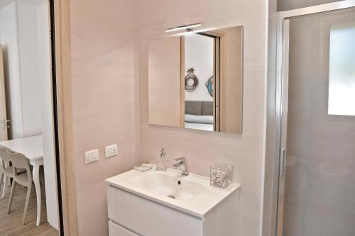 a bathroom with a sink and a mirror at Altomare Case Vacanza in Porto Cesareo