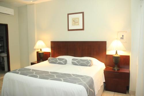 a bedroom with a bed with two pillows on it at Hotel Posada Doña Rubino in Mazatlán