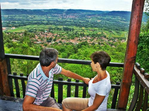 a man and a woman sitting on top of a tower at Vila Milenovic Rajacke Pivnice in Rajac