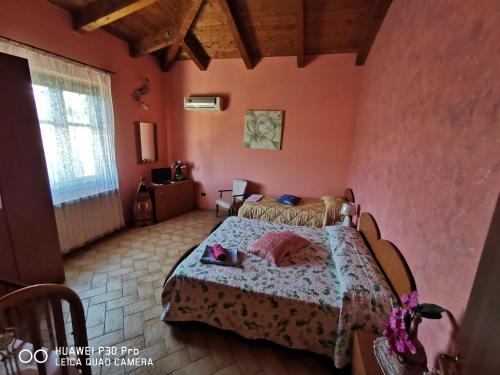 a bedroom with a bed in a room with pink walls at Bed And Breakfast "ANNA" in Bagnara Calabra