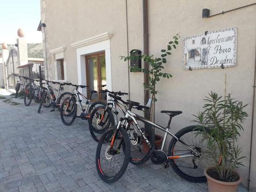 a row of bikes parked next to a building at Il pozzo dei desideri in Castelnuovo