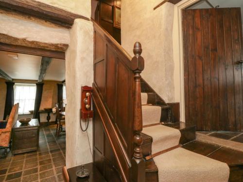 a stairway in a home with a wooden door at The Pend in Newton Stewart