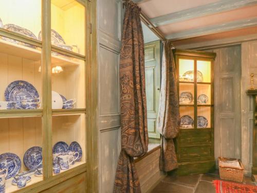 a dining room with blue and white plates and a door at The Precinct House in Newton Stewart