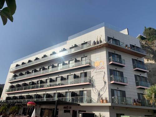 a large white building with people on balconies at ON ALETA ROOM designed for adults in Almuñécar