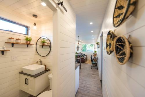 a bathroom with a sink and a toilet in a house at The Woods- Container Tiny House 12 min to Magnolia/Baylor/Downtown in Bellmead