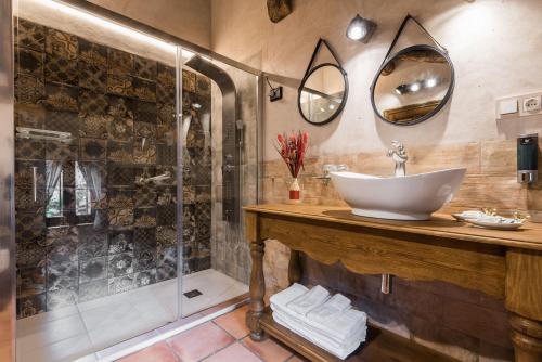 a bathroom with a sink and a shower at Posada del Rodeno in Albarracín