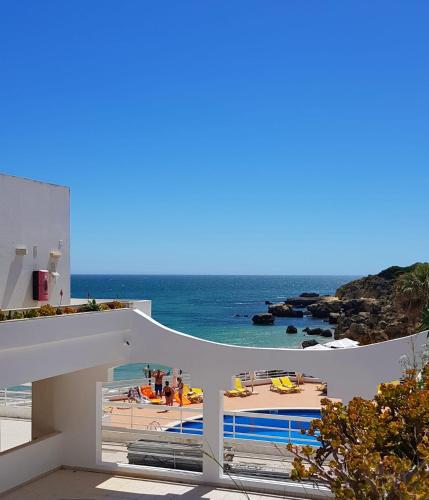 a view of the beach from a white house at Oura Ocean Front in Albufeira