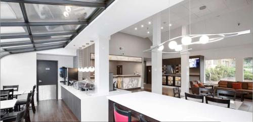 a kitchen and living room with a table and chairs at Best Western Plus Parkway Inn in Wilsonville