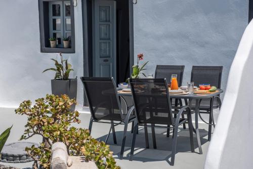 a table and chairs sitting on a patio at Noelia Suites in Oia