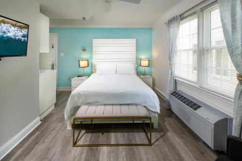 a bedroom with a white bed and a window at Canalside Inn in Rehoboth Beach