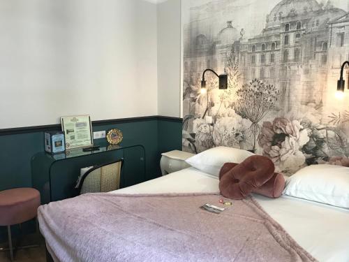a bedroom with two beds and a wall mural at Le Grand Hôtel Mont Dore in Le Mont-Dore