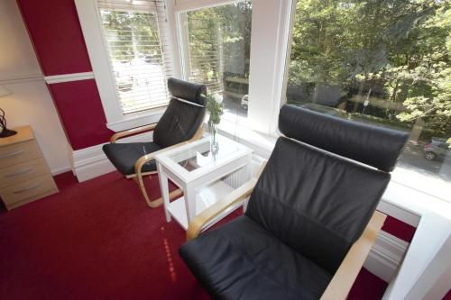 two chairs sitting in a room with a window at The Dales in Harrogate