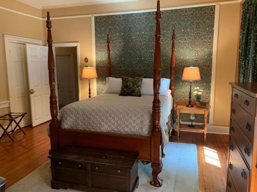 a bedroom with a bed with a wooden frame at The Lily Inn - Burlington in Burlington