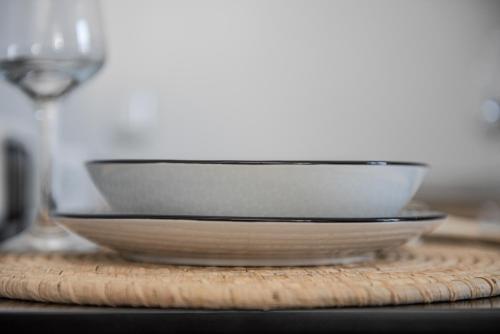 a white bowl sitting on top of a wooden table at Noelia Suites in Oia