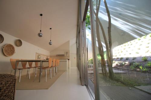 a kitchen and dining room with a table and chairs at Slope Design Villa - Architecture villa with private pool in Ponte de Lima