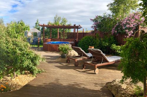 a backyard with two lounge chairs and a pool at The White House in Reykholt