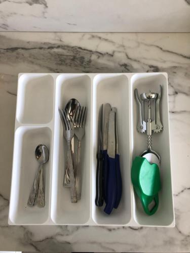 a plastic tray filled with utensils on a counter at B&B Le Palme in Cassino