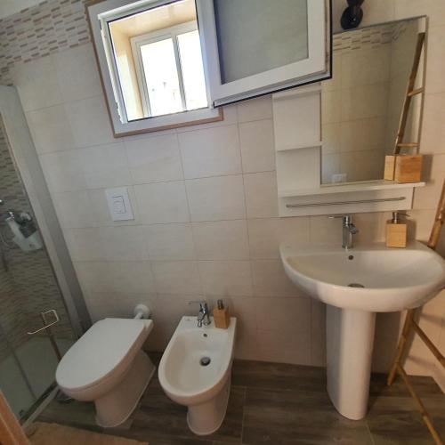 a bathroom with a sink and a toilet at Angela's House in Taranto