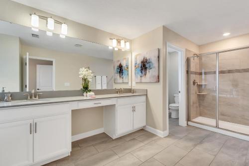 a bathroom with a shower and a sink and a toilet at Stylish Home wPrivate Pool&Spa, near Disney in Davenport