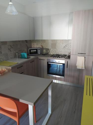 a kitchen with white cabinets and a stove top oven at Alex's home 2 in Crone