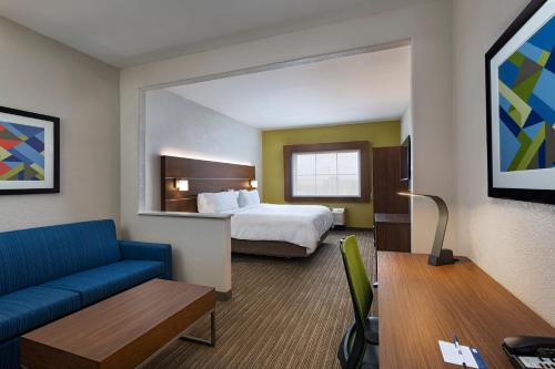a hotel room with a bed and a couch at Holiday Inn Express & Suites Cedar Park (Nw Austin), an IHG Hotel in Cedar Park