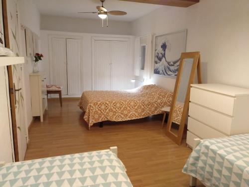 a room with two beds and a dresser in it at Chalet con Piscina - LAS ADELFAS in Chiclana de la Frontera