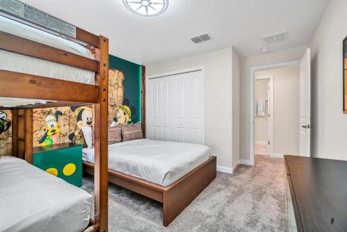 a bedroom with two bunk beds and a table at Private Pool Themed Bedrooms FREE Waterpark in Kissimmee
