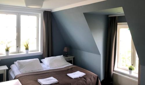a bedroom with a bed with two towels on it at The White House in Reykholt