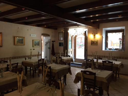 a restaurant with tables and chairs in a room at Albergo Andromeda in Pescasseroli