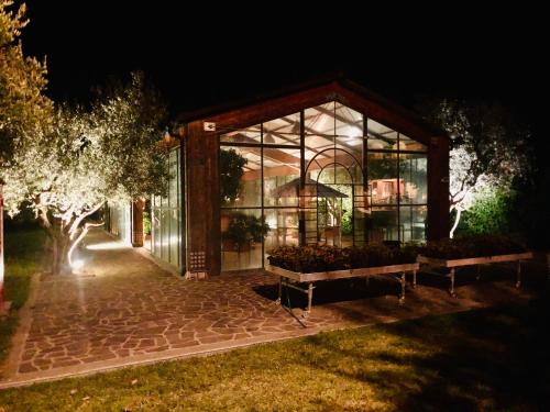 a glass building with benches in front of it at night at Pian De' Somari in Pitigliano