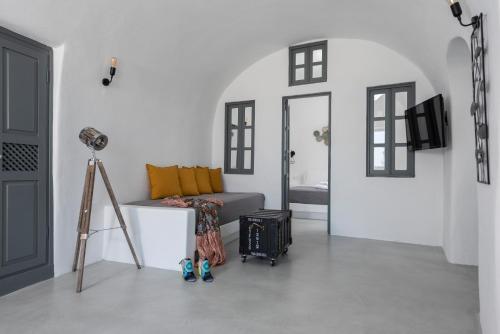 a living room with a couch and a camera at Noelia Suites in Oia