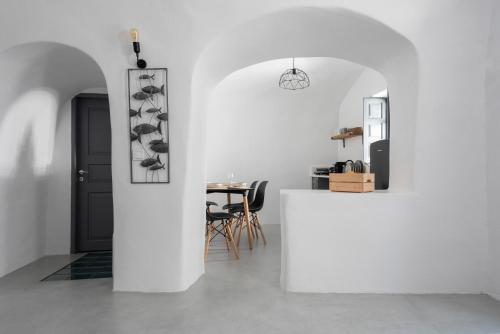 a white room with a table and a white wall at Noelia Suites in Oia