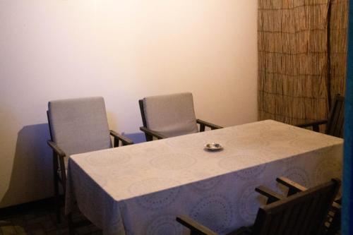 a table and two chairs in a room at Hotel Living in Šuto Orizari