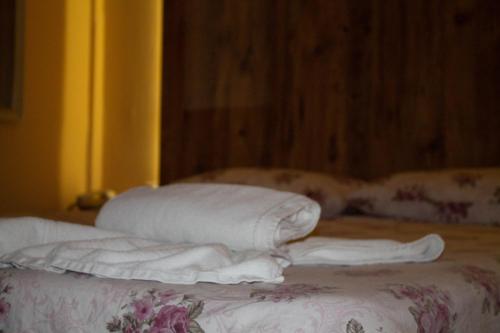 a group of pillows sitting on top of a bed at Hotel Living in Šuto Orizari
