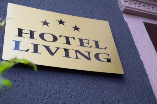 a hotel wing sign on the side of a building at Hotel Living in Šuto Orizari