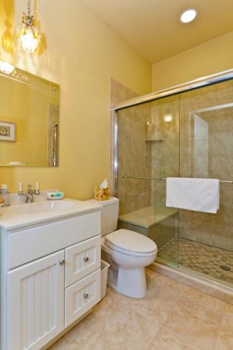 a bathroom with a toilet sink and a shower at The Lily Inn - Burlington in Burlington