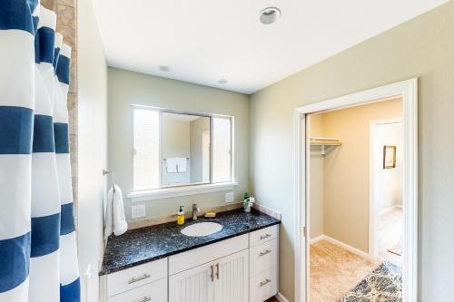 a bathroom with a sink and a mirror at Waterfront Getaway in Poulsbo