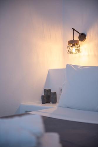 a room with a lamp and two candles on a shelf at Noelia Suites in Oia