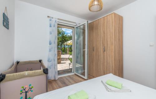 a bedroom with a bed and a sliding glass door at Apartments Mioković in Soline