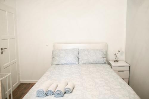 a bedroom with a bed with two slippers on it at Best Apartment in Tarnów