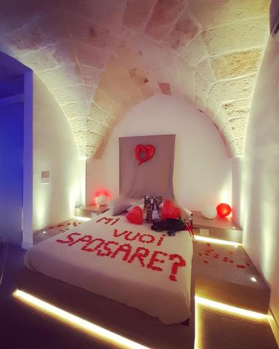 a bedroom with a bed with a heart on it at Christian's Suites & Spa in Fasano