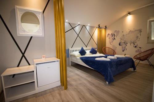 a bedroom with a bed and a mirror at Hotel Villa Nadin in Mostar