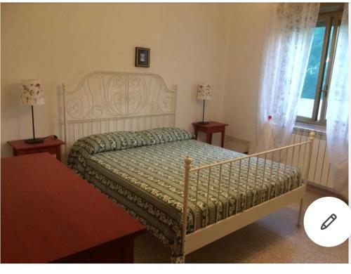a bedroom with a bed and two tables and a window at VILLA A 200 METRI DAL MARE in Castelvetrano Selinunte