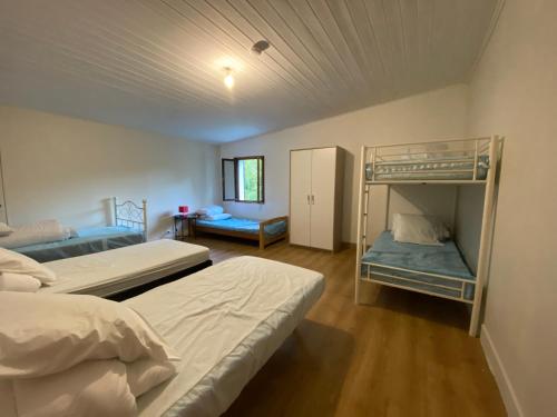 a bedroom with two bunk beds in a room at Villas-des-eaux Douces in Marsac