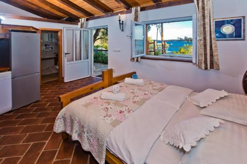 a bedroom with a bed with a view of the ocean at Apartments Villa Marcelina in Hvar