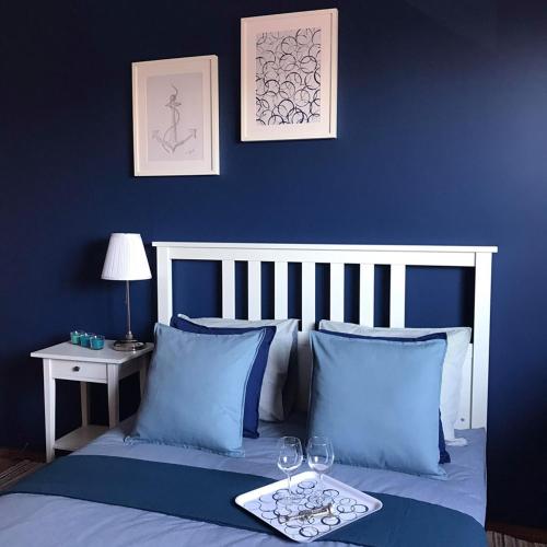 a blue bedroom with a bed with blue walls at Międzywodami Jastarnia in Jastarnia