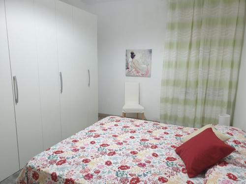 a bedroom with a bed with a quilt on it at Chiara Naxos Apartment in Giardini Naxos
