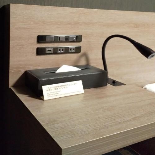 a black printer sitting on a table with a lamp at Hotel Route-Inn Kawaguchiko in Fujikawaguchiko