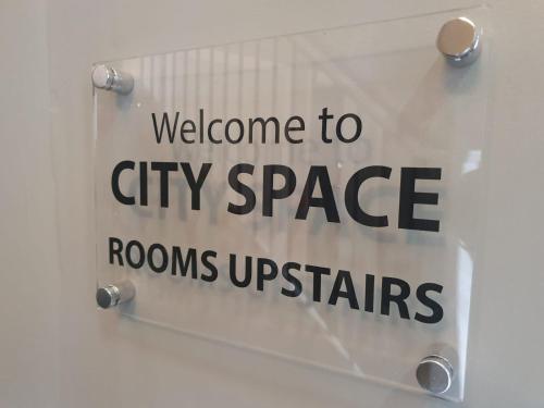 a sign that says welcome to city space rooms upstairs at City Space in Doncaster