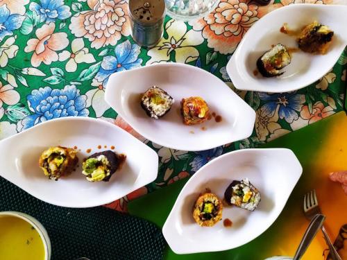 a table topped with white plates of food at Skale Peregrino in Choachí